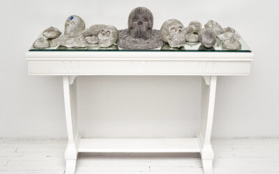 Esperanza Cortés; SECOND SIGHT; 2008 – 2018; 20 clay sculptures, glass beads, mirror, table. Second Sight honors the Curandera (healer) in Latinx culture as a whole, as well as the personal connection to my grandmothers who were both curanderas in Colombia. These individuals dedicated their lives to maintaining the physical and spiritual well being and equilibrium of their families and communities. Each individual piece represents the instruments and fruits of their Labors.