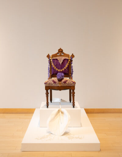 Esperanza Cortés; CHARLOTTE; 2019; Chair, embroidery, four plaster flowers with pearl necklaces. This work is influeced by the naming of the city of Charlotte, North Carolina and the history of Queen Charlotte.
