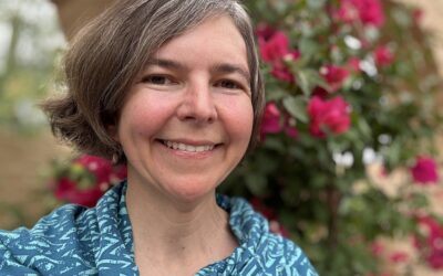 Smiling woman with blue patterned shirt