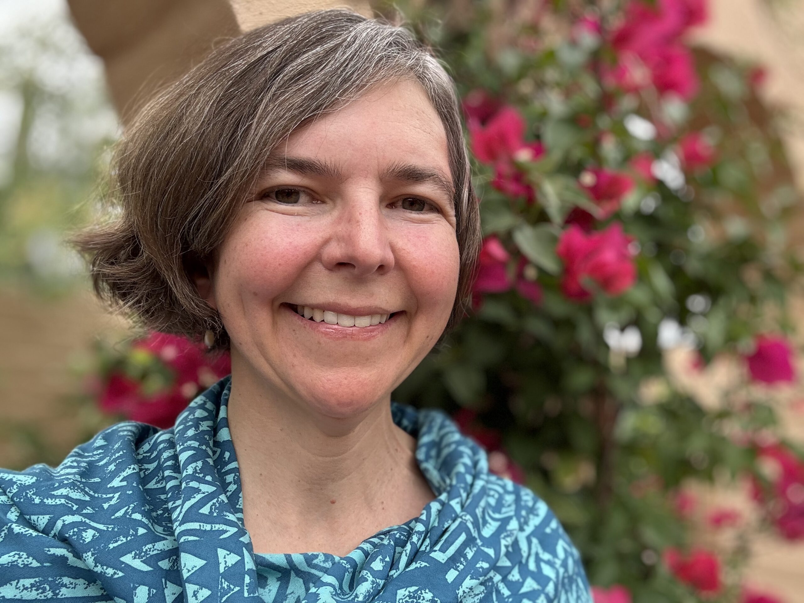 Smiling woman with blue patterned shirt