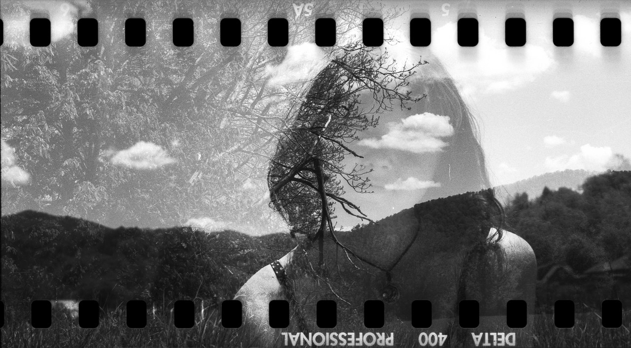 film slide in black and white depicting a woman and mountain range