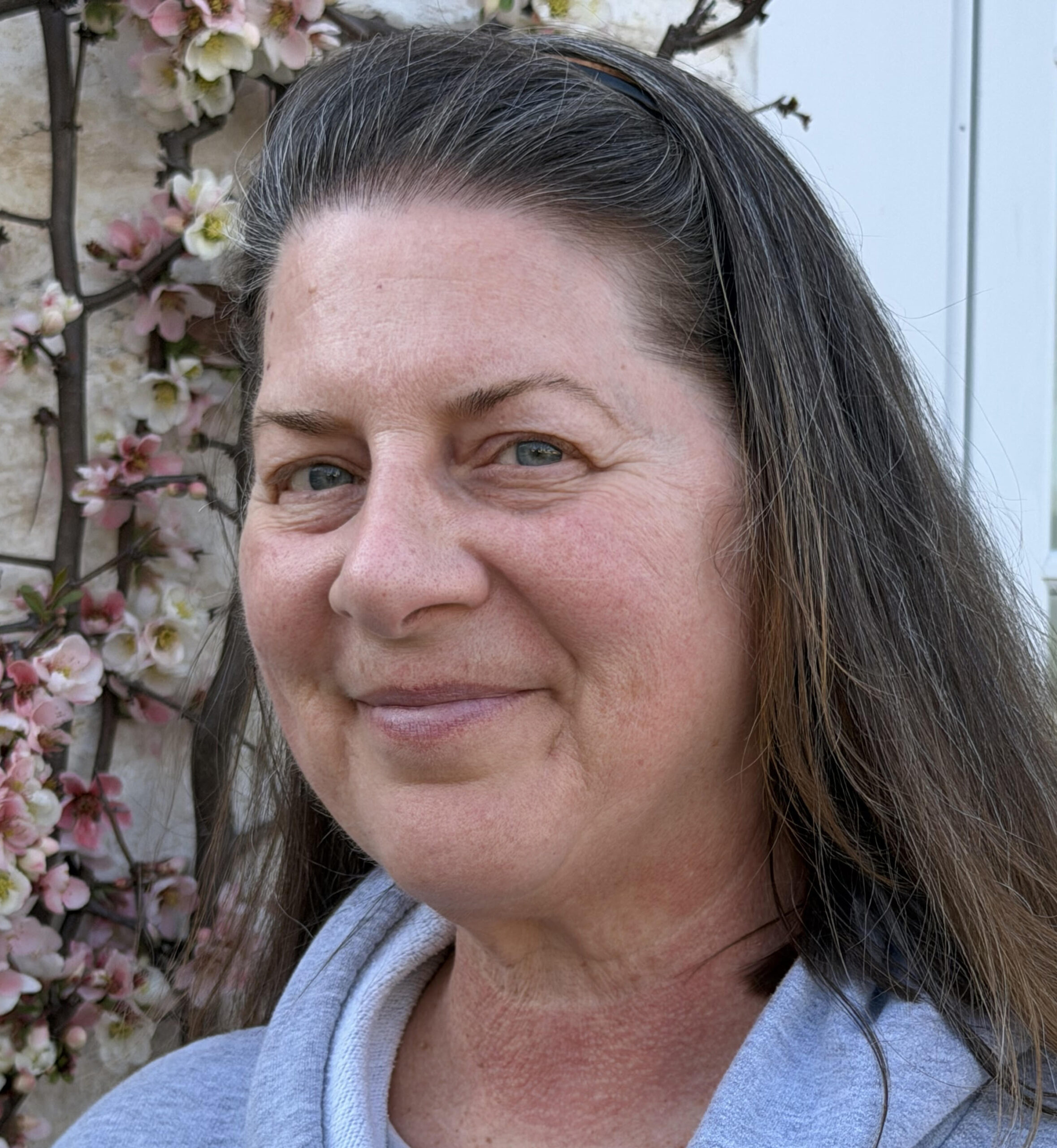 Photo of woman with dark hair and grey top