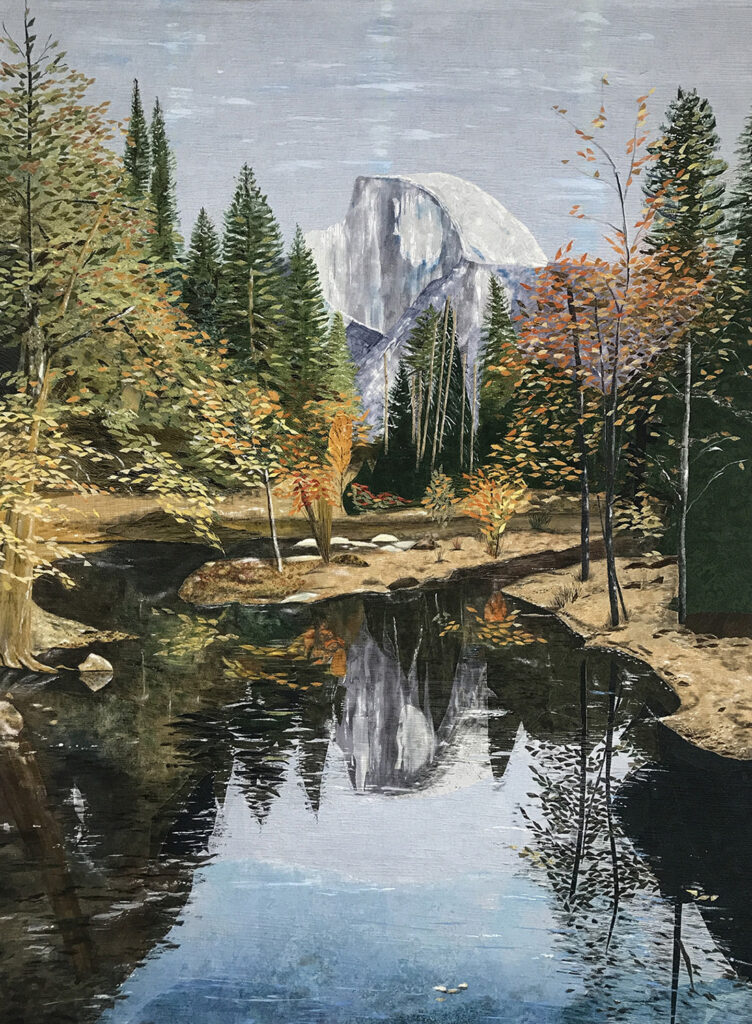 Yosemite mountain in background with trees and pool of water in front