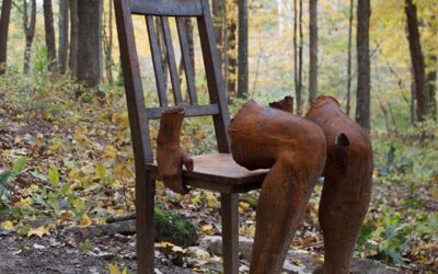 Sculpture of legs on a chair in the woods