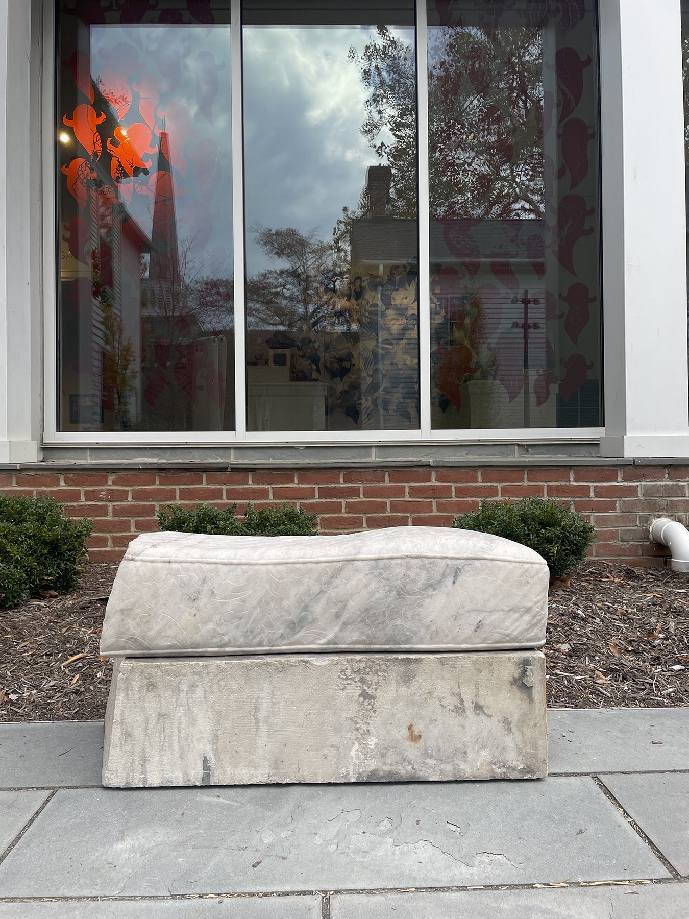 sculpture of stone bench outside building