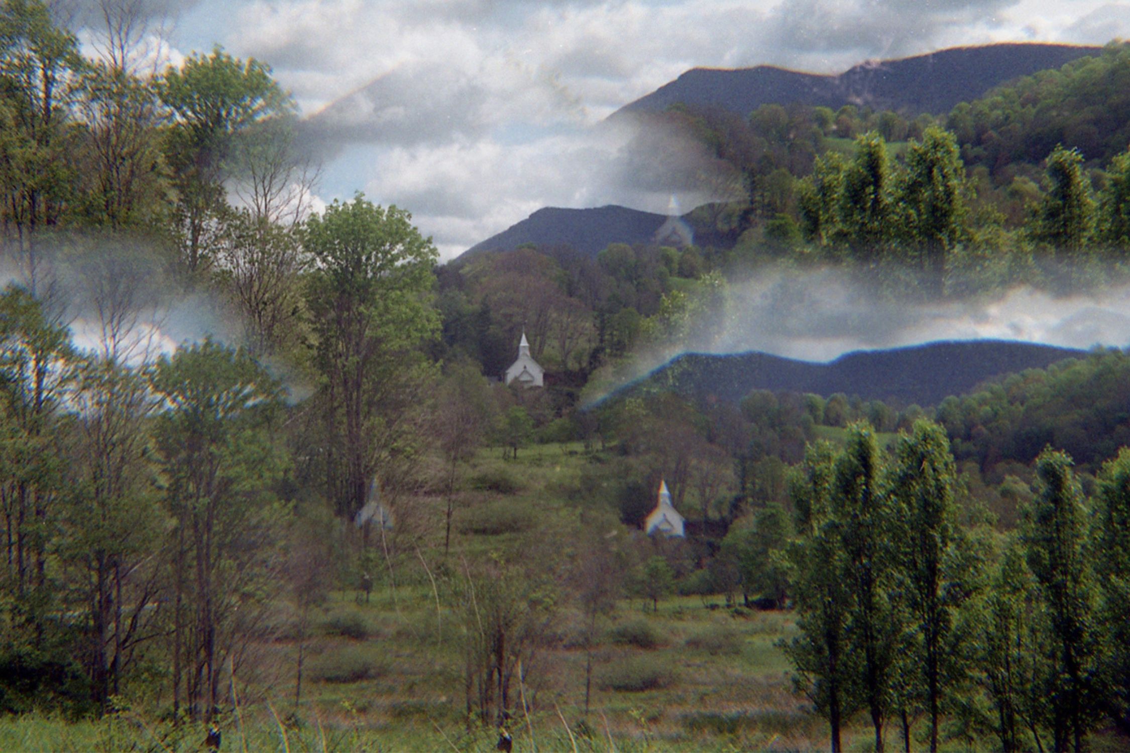 Multilayer image of mountains with church and clouds